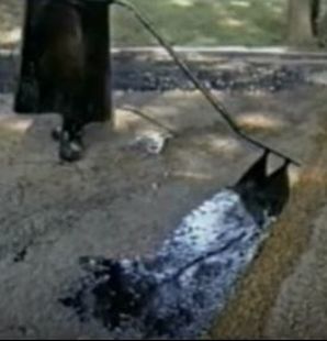 Spreading Tar by Hand on Small Driveway Jersey Strong Paving NJ